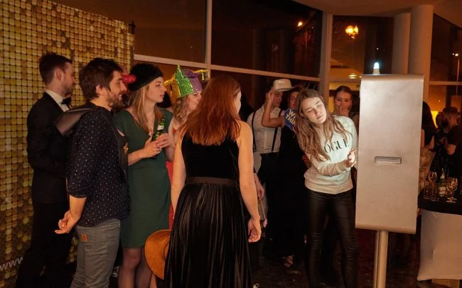 Large group using a photo booth