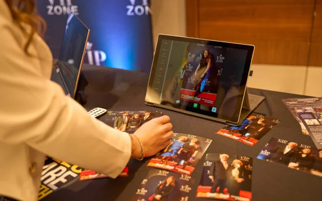 Printed photos on a table and displaying on screen