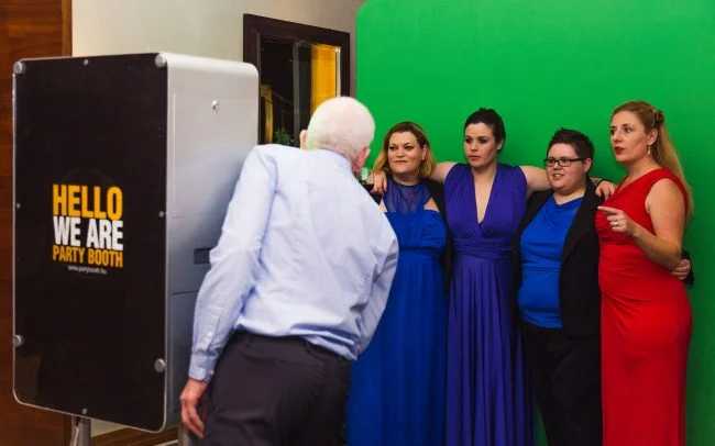 Group of people using a photo booth